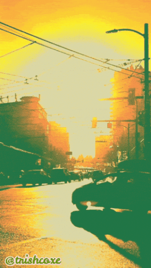 Green and yellow-orange animated photorealistic gif of car traffic at an intersection