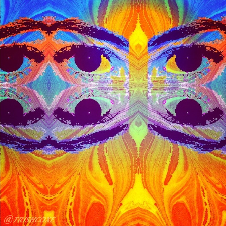 digitized eyes with blue detail over an orange marbled background